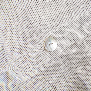 Fabric pattern linen gray and white striped with mother of pearl button detail. 