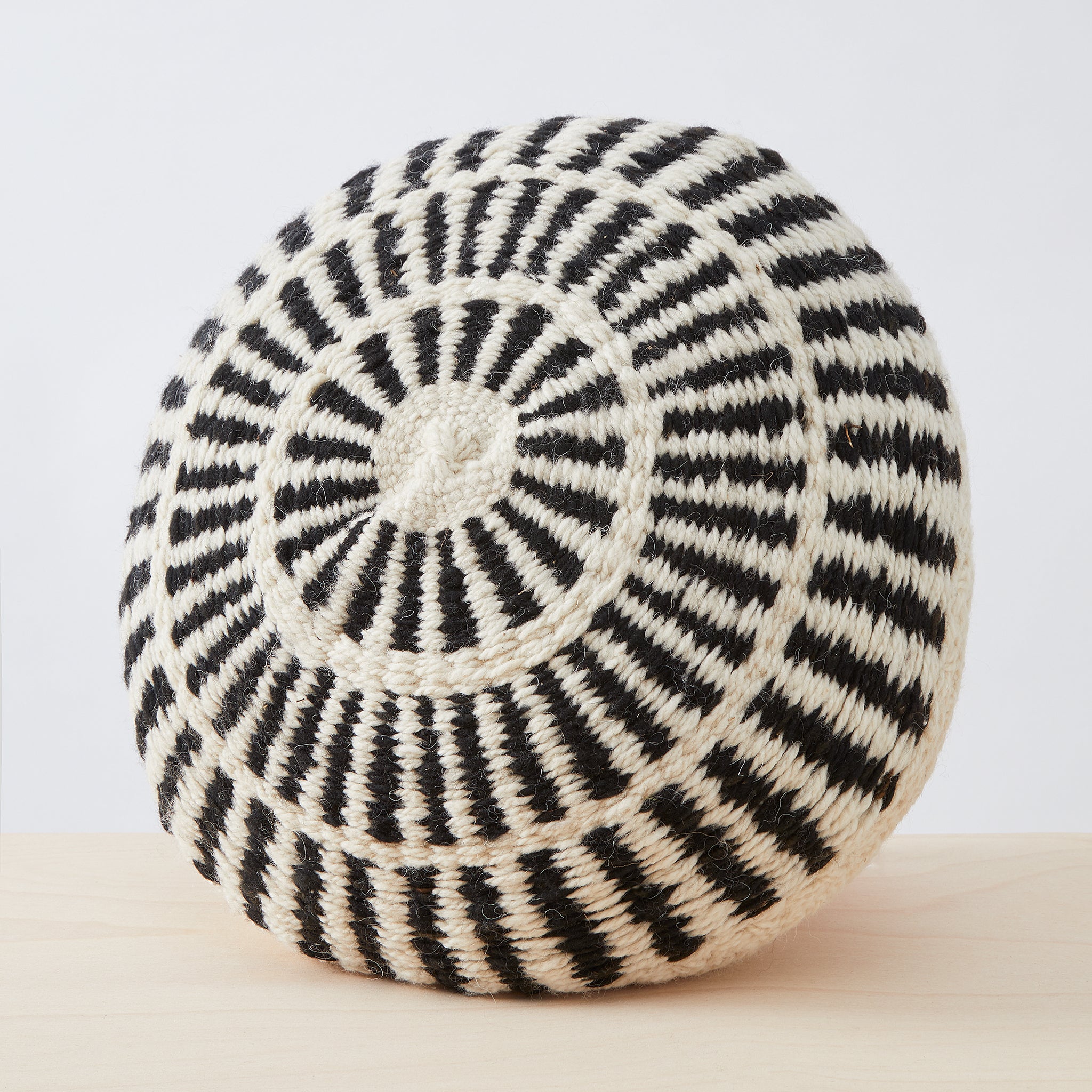 Individual handmade cushion in 100% Argentinian sheep's wool with a traditional pattern in natural white and black.