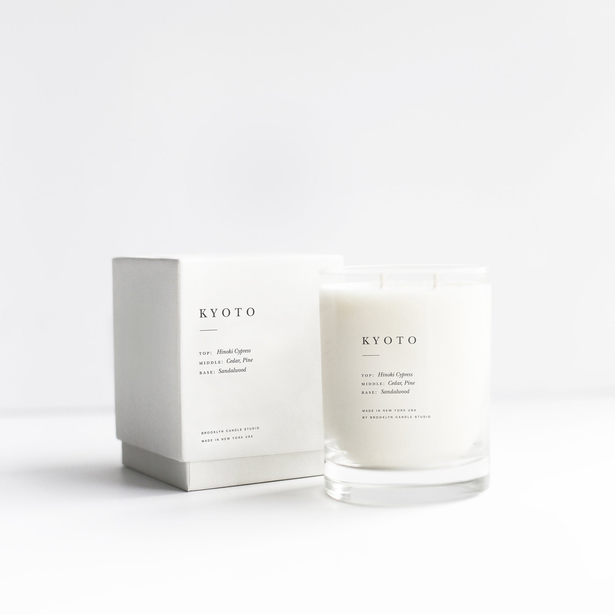 Brooklyn Candle Studio scented candle Kyoto series Escapist. A romantic homage to Kyoto in the rain, green avenues and Japanese wooden architecture. This wonderful scented candle is a meditative, calming composition of Hinoki cypress, cedar, sandalwood, vetiver and pine. Hand-poured with 100% soy wax in the small manufactory of Brooklyn Candle Studio.