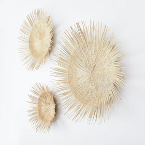 Three sun plates in sizes L, M and S. Woven by hand in Malawi from palm leaves. 