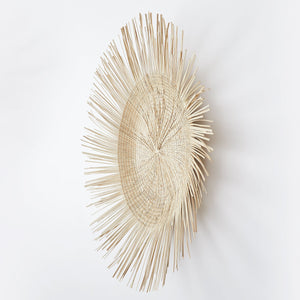Side view with shadow play: BY NATIVE Sun plate small, hand-woven from palm leaves in Malawi