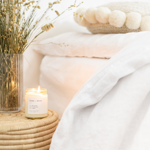 Detailed view of white linen bedding in the bedroom.